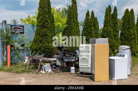 Old appliances outside of a junk yard on Main Street in Frewsburg, New York, USA Stock Photo