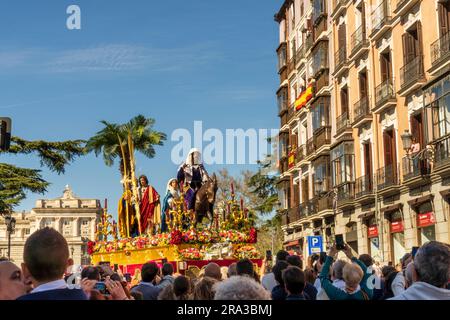 Holy Week parades in Madrid, Spain. Religious floats, Pasos, are carried through the streets with marching bands and spectators during Semana Santa. Stock Photo