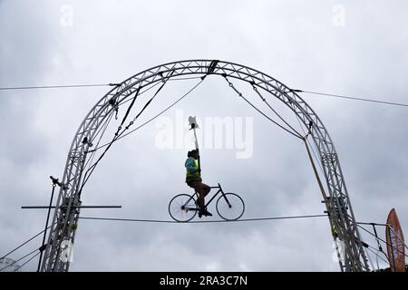 Coventry, UK. 30th June, 2023. Colombian aerial acrobat Andres Meneses rehearses for his bicycle performance on the 15ft high wire at Coventry's Godiva Festival. The festival begins on Friday June 30th and goes on until late Sunday July 2nd. Credit: Peter Lopeman/Alamy Live News Stock Photo