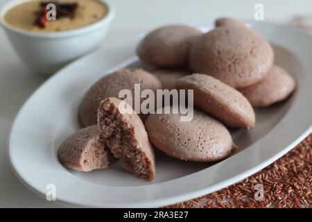 Navara rice idly. Steamed savoury rice cake made by a batter of fermented de husked black lentils and navara rice. Navara rice is an endemic rice with Stock Photo