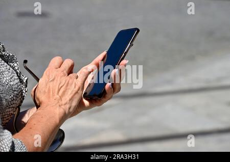 Woman holding smart phone in hand Stock Photo