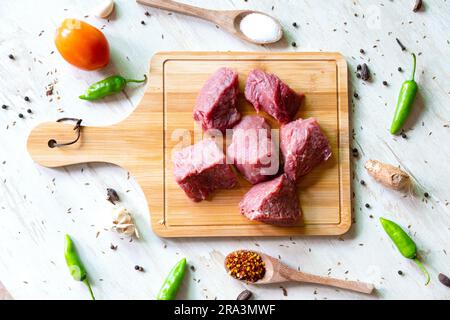 diced raw beef meat on wooden cutting board Stock Photo - Alamy