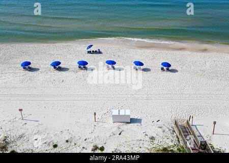 Blue Beach Chairs with Umbrellas on White Sand on Gulf Shores Beach Stock Photo