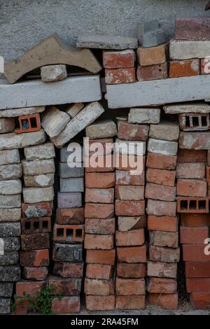 pile of reclaimed red bricks ready for use in restoration project. reclaiming building materials. stacked red building bricks. Stock Photo