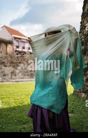 Ballerina in traditional costume shows her eyes Stock Photo