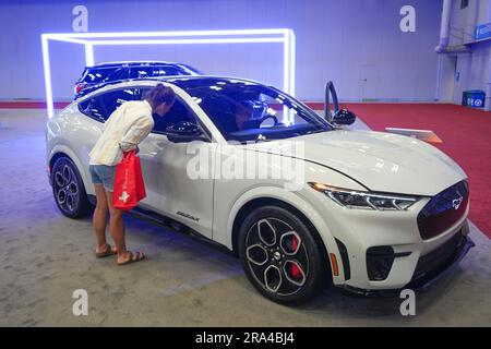 Austin, USA. 30th June, 2023. People look at an all-electric vehicle at the 2023 Austin Auto Show in Austin, Texas, the United States, on June 30, 2023. The 2023 Austin Auto Show kicked off here on Friday. Credit: Bo Lee/Xinhua/Alamy Live News Stock Photo