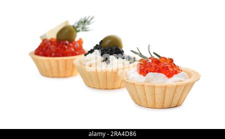 Delicious tartlets with red and black caviar on white background Stock Photo