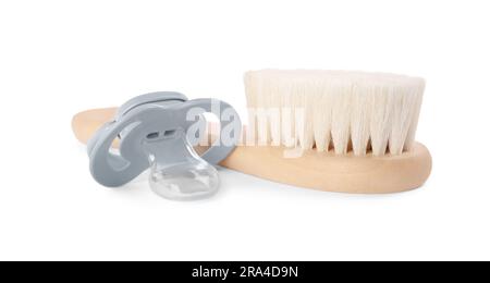 Hairbrush and baby pacifier isolated on white Stock Photo