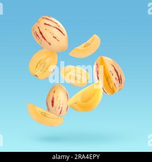 Fresh ripe pepino melons falling on light blue background Stock Photo