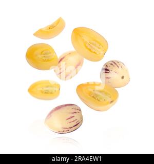 Fresh ripe pepino melons falling on white background Stock Photo