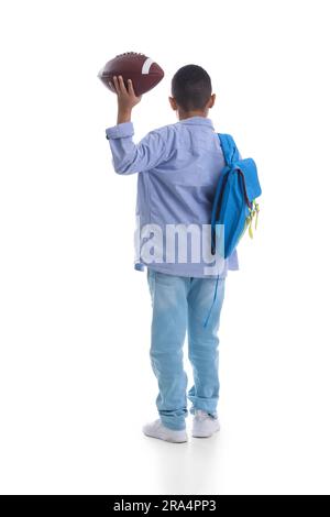 Little schoolboy with blue backpack and rugby ball on orange background ...