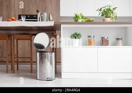 Opened trash bin in interior of light kitchen Stock Photo