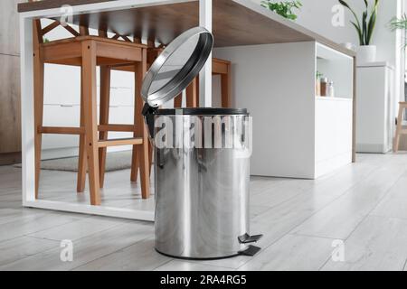 Opened trash bin in interior of light kitchen Stock Photo