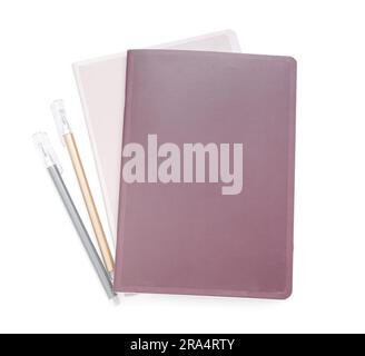 Different notebooks with pens isolated on white background Stock Photo