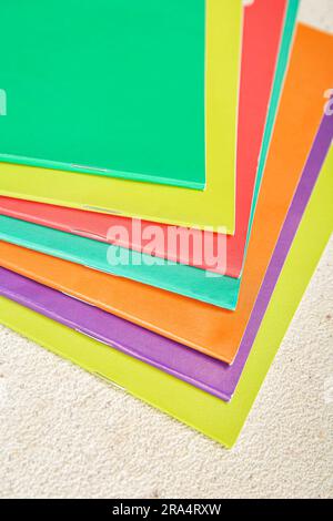 Different colorful notebooks on grunge light background Stock Photo