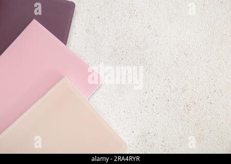 Different colorful notebooks on grunge light background Stock Photo