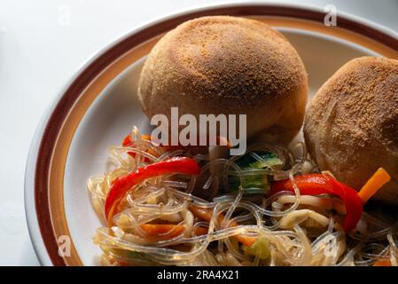 Pandesal or pan de sal with pancit - a Filipino snack combination Stock Photo