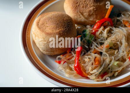 Pandesal or pan de sal with pancit - a Filipino snack combination Stock Photo