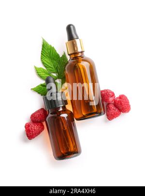 Bottles of cosmetic raspberry oil on white background Stock Photo
