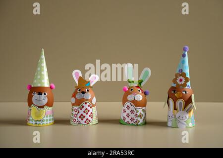 Easter egg figurines DIY. Easter rabbit figurine with colorful eggs. Easter eggs. Funny hares. toy rabbit. toy egg. Statuette easter bunny. Stock Photo
