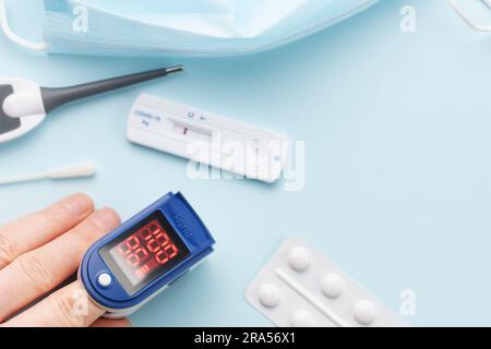 Pulse oximeter measuring oxygen saturation in blood and heart rate.  Pulse oximeter on the patient's hand Stock Photo