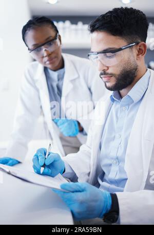 Results, teamwork or scientist writing research notes for analysis on experiment, medical info or innovation. Science, biotechnology or a in a Stock Photo