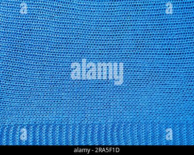 Knitted background.Texture of rough knitting from blue woolen threads. Stock Photo