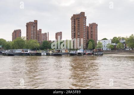 Reflections from World's End apartment buildings as they cast their shadow on The River Thames at Lots Road, Chelsea, London, England, U.K. Stock Photo