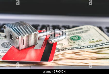 Concept of online payment with card, security and finance. Open padlock with credit card and dollar bills Stock Photo