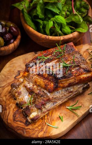 Roasted pork with olives and salad Stock Photo
