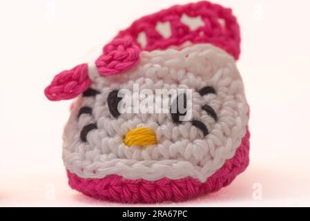 shoes with faces for a newborn, crocheted, on a white background Stock Photo