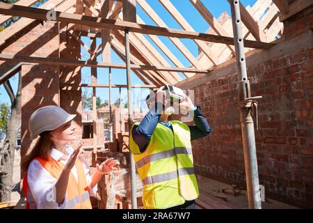 Male customer wearing virtual reality glasses to see house after building Stock Photo