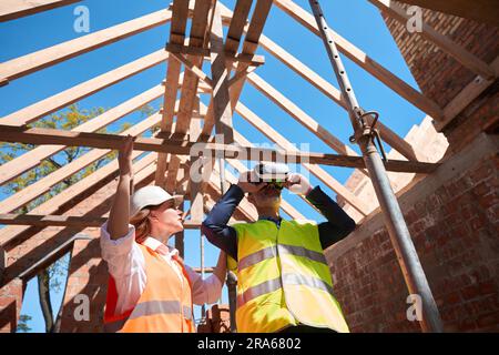 Main construction worker wearing vr-glasses to see 3d model of house Stock Photo