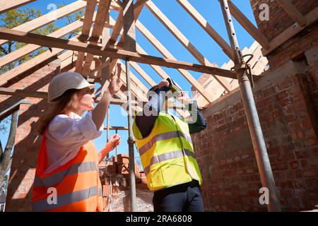 Foreman using virtual reality headset for vision of constructed building result Stock Photo