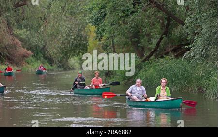 Ditfurt, Germany. 01st July, 2023. Water sports enthusiasts ride canoes on the Bode River. A boat rental offers water recreation on the Bode. Visitors can experience the Bode and the Bode floodplain on a long section from the waterway and make acquaintance with the diverse flora and fauna along this river. The tours can last from three to six hours. Credit: Matthias Bein/dpa/ZB/dpa/Alamy Live News Stock Photo