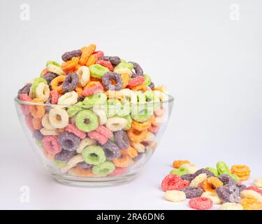 Bowl of colorful crispy corn rings on white background. Breakfast cereal Stock Photo