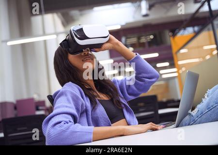 Pretty female using vr technologies in modern room Stock Photo
