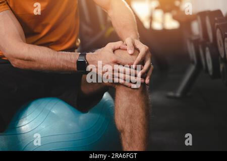 closeup man hand holding support knee injury. sport male pain suffer from patella or knee cap ligament pain Stock Photo