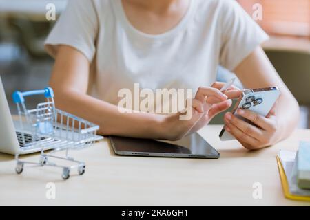 closeup woman hand using smartphone marketing app for online shopping buying modern lifestyle people. Stock Photo