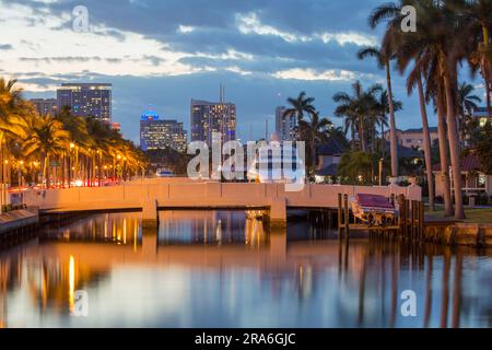 Fort Lauderdale, Florida, USA. View along tranquil waterway in the Nurmi Isles district, dusk, illuminated Downtown skyscrapers in background. Stock Photo