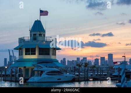 Miami Beach, Florida, USA. View at dusk across Miami Beach Marina from South Pointe Park, South Beach, Downtown Miami in background. Stock Photo