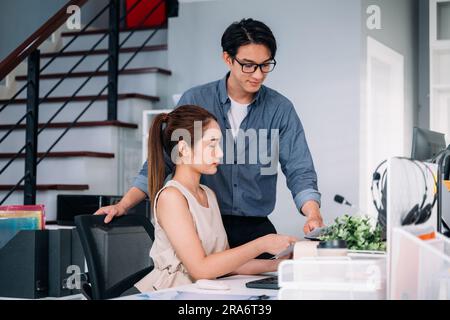 Couple of business people working together at modern office Stock Photo