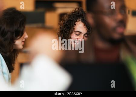 Young curly haired man laughing Stock Photo