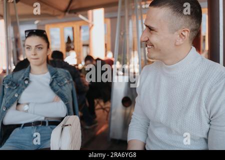 Close up of handsome man smiling while looking away at the cafe Stock Photo