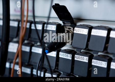 Sound plugin audio cable on studio system boxes. Stock Photo