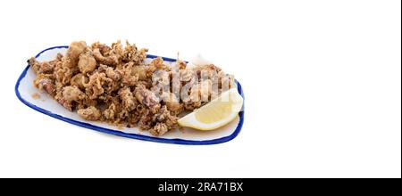 Spanish tapa of small squid in batter fried with lemon on a white background with copy space on the side. Spanish cuisine concept Stock Photo