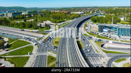 Multilevel city highway junction in Krakow, Poland. One highway on the top level, the second one in the tunnel, the turnaround with traffic lights and Stock Photo