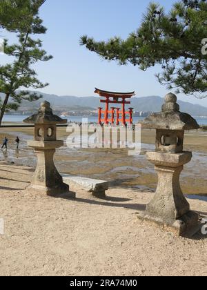 Red torii gate and stone lanterns in Kasuga Taisha Shrine in Nara ...