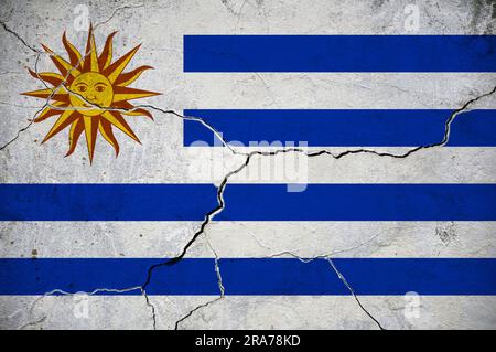 An image of the Uruguay flag on a wall with a crack. Stock Photo