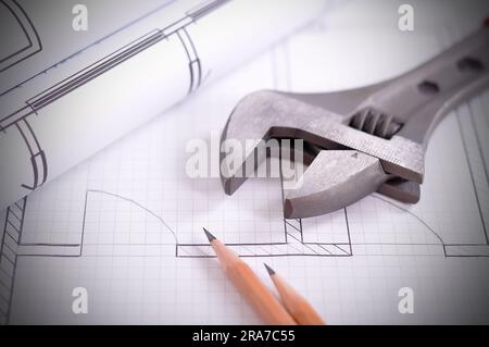 wrench and sketches blueprint  on the table Stock Photo